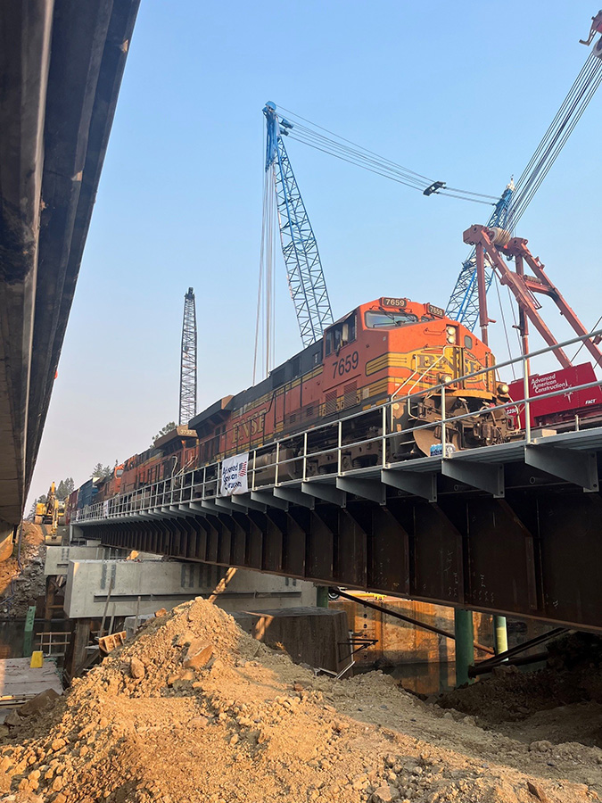 The first train runs across the new bridge on Aug. 3. 