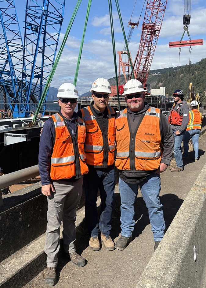 BNSF team members on the bridge replacement site. From left, Jeff Swanson, general director of line maintenance; Edmundo Rodriguez, general manager; and Chad Gordon, manager of structures.